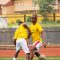Two young men engaged in soccer training on an outdoor field. Active sports scene.